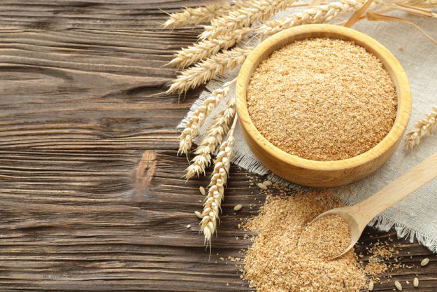 Bran in a bowl and wheat ears X Benefits Of Consuming Fiber In Your 50s