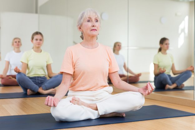 Elderly woman practice yoga lotus pose X Meditation Techniques You Can Try
