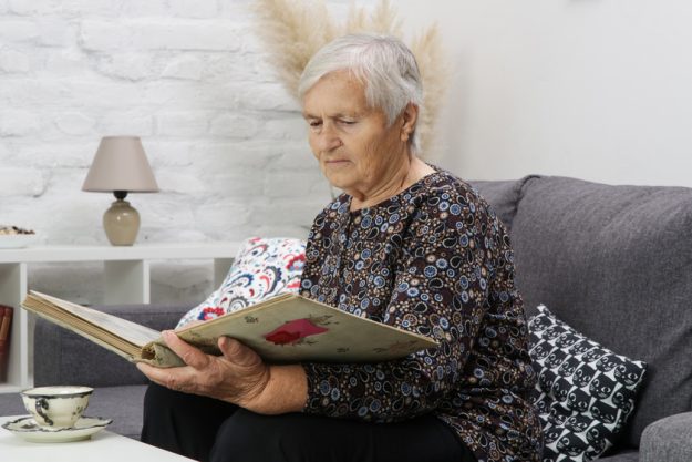 Grandmother looking at family photo album. Nostalgia and memorie tips-for-touring-memory-care-in-new-orleans,-la-img