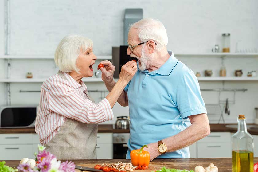 senior couple feeding each other senior couple feeding each other