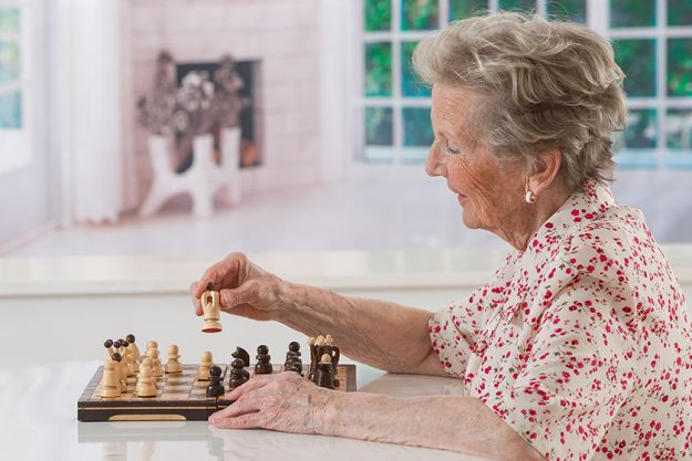 Senior woman playing chess