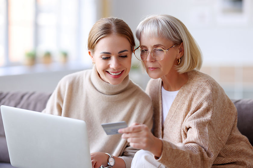 Young daughter and mature mother sitting