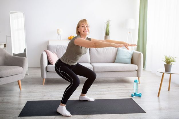Home workout concept. Beautiful mature lady Home workout concept. Beautiful mature lady