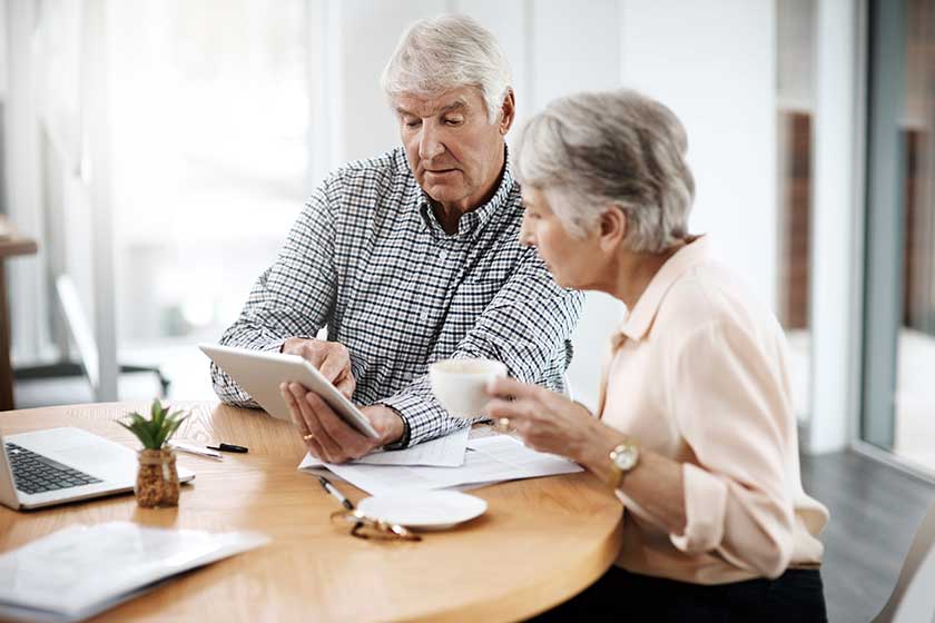 Making sound financial decisions. High angle shot of a senior couple working on their finances at home. Making sound financial decisions. High angle shot of a senior couple working on their finances at home.