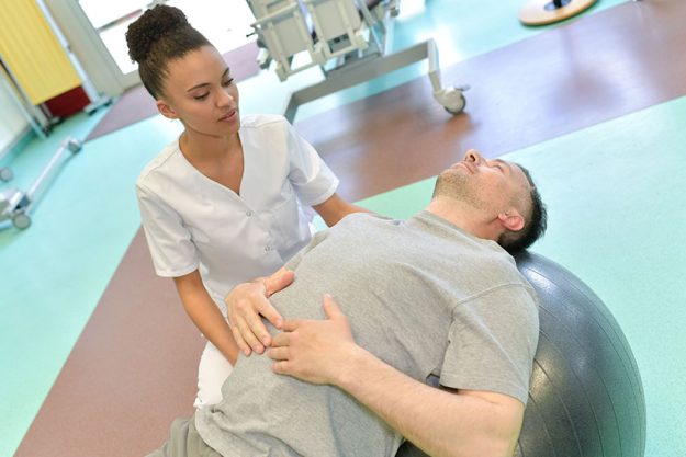 Modern rehabilitation physiotherapy with ball Modern rehabilitation physiotherapy with ball