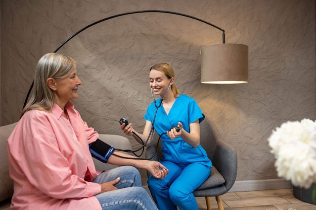 Nurse or doctor checking blood pressure to senior woman in medical care center. Nurse or doctor checking blood pressure to senior woman in medical care center.