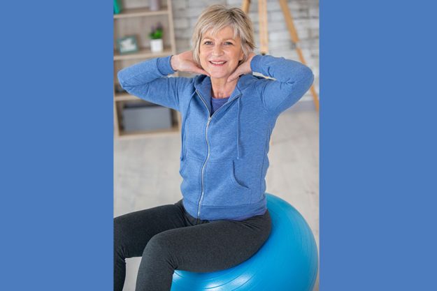 Aged blond woman on fitness ball
