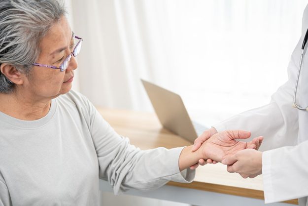 Helping hands, care for the elderly concept. doctor use hand screening vital sign of old asian patient. Doctor checking patient's pulse - medical concept