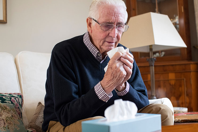 Senior Man At Home Suffering With Cold Or Flu Virus