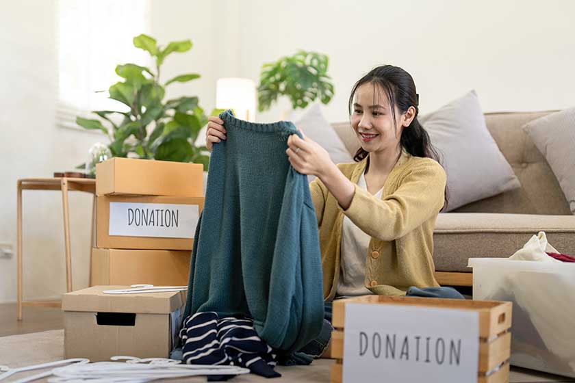 Woman-asian-holding-donation-box-full-clothes-select-clothes-concept