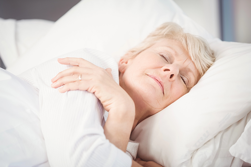 senior-woman-sleeping-on-bed