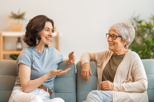beautiful-mother-daughter-talking-smiling-while-sitting Beautiful mother and daughter are talking and smiling
