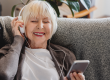 Happy mature old woman wear headphone