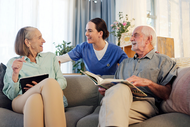 senior-couple-caregiver-happy-couch Senior couple, caregiver and happy on couch in retirement