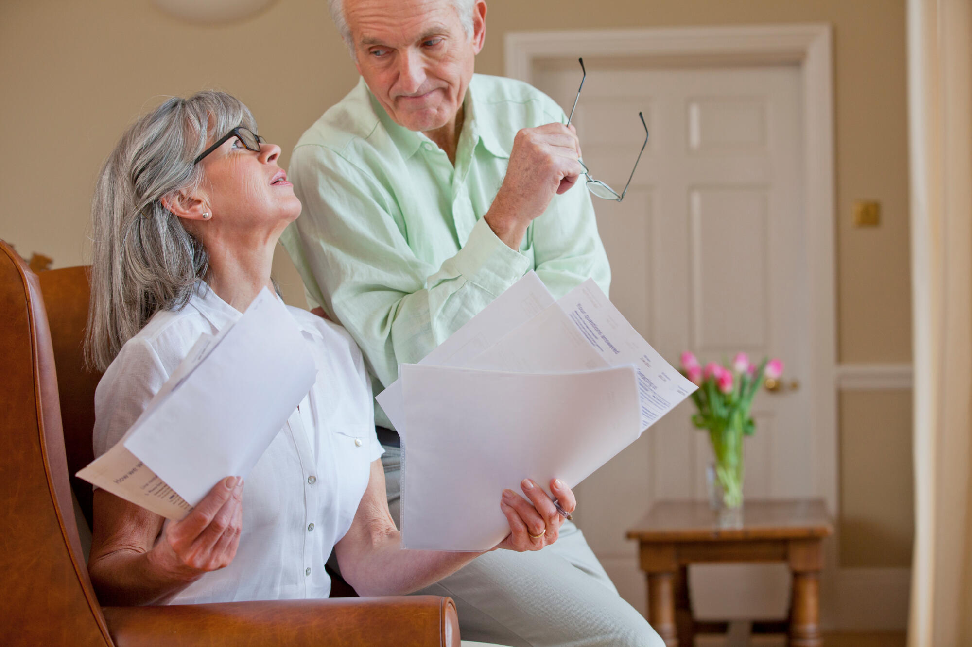 Horizontal,Shot,Of,A,Senior,Couple,Discussing,Paperwork,With,The