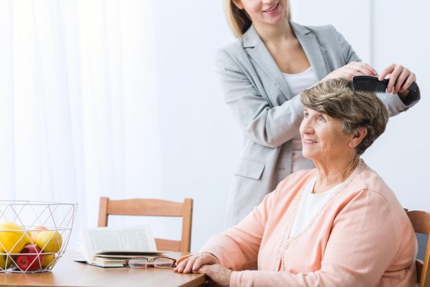 Horizontal,View,Of,Granddaughter,Combing,Grandma’s,Hair