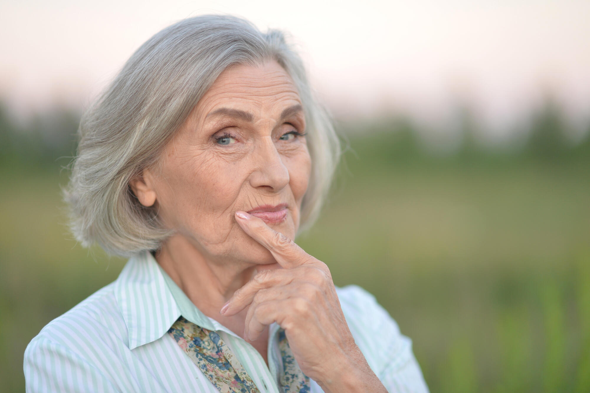 portrait of a happy senior woman in park